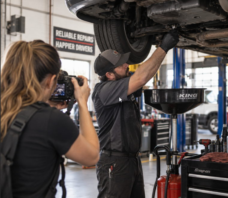 Professional photographer creating original content inside an auto repair shop